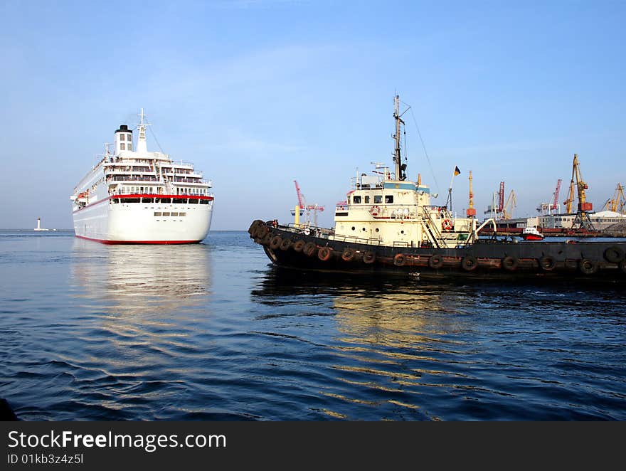 Tugboat sees off the passenger ship from port harbour