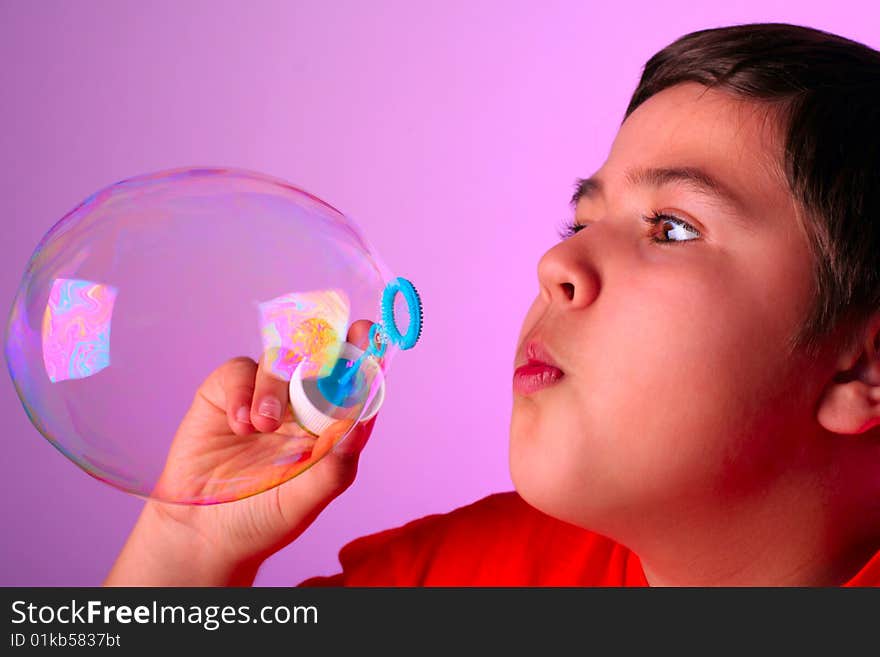 boy blowing soap bubbles