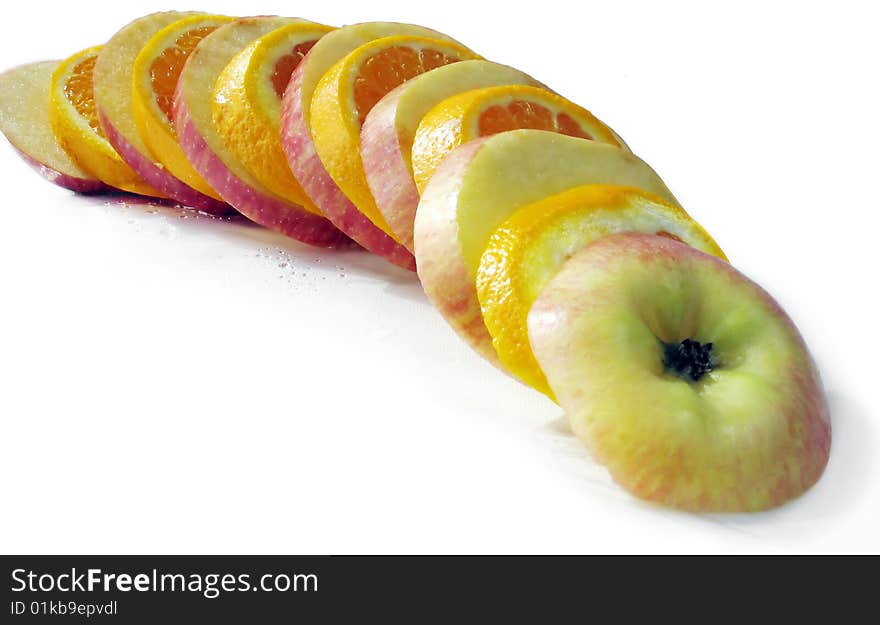 Fruit slicing of apples and oranges on a white background