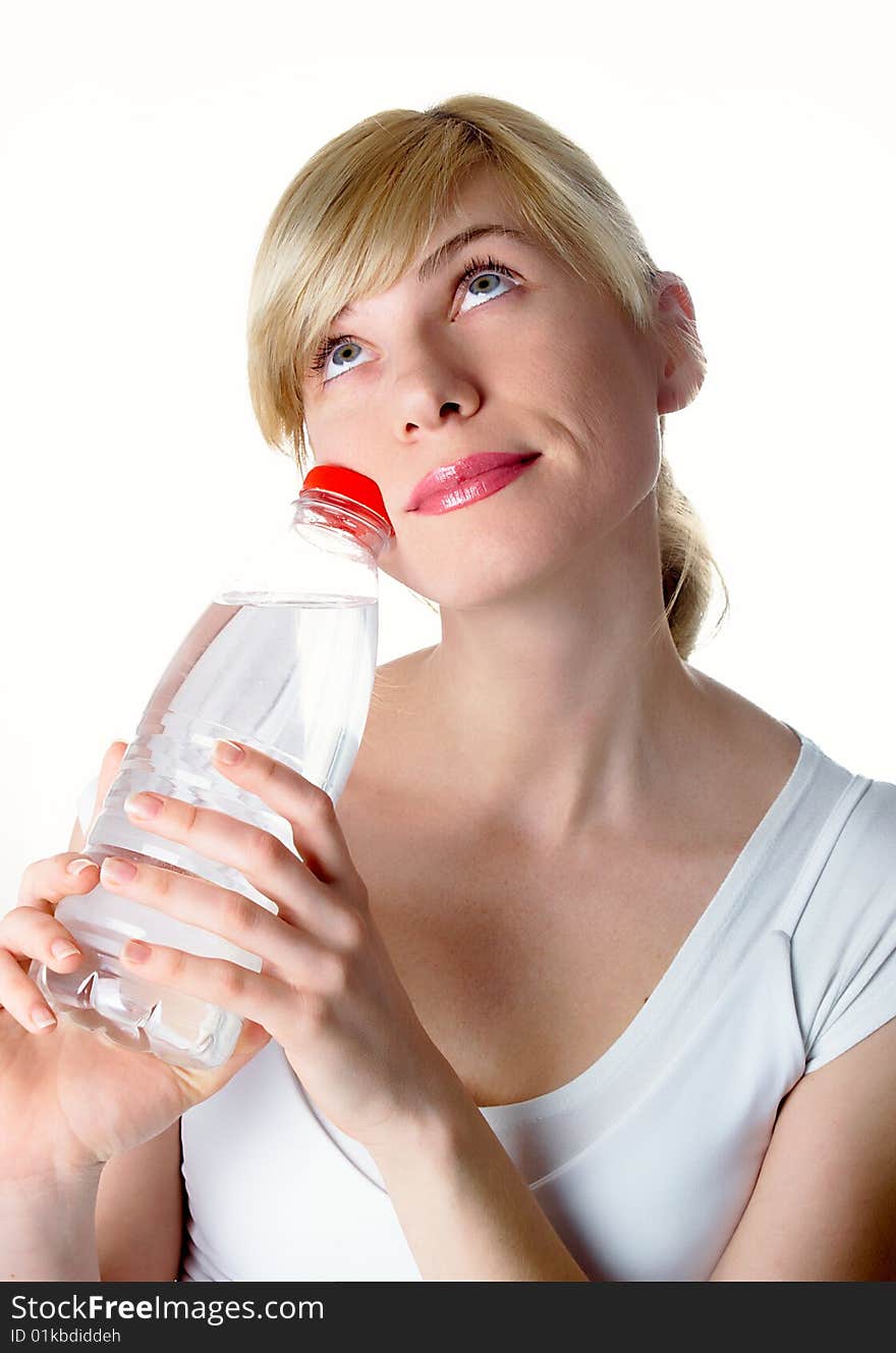 The girl of a sports kind with a bottle of water in a hand. The girl of a sports kind with a bottle of water in a hand