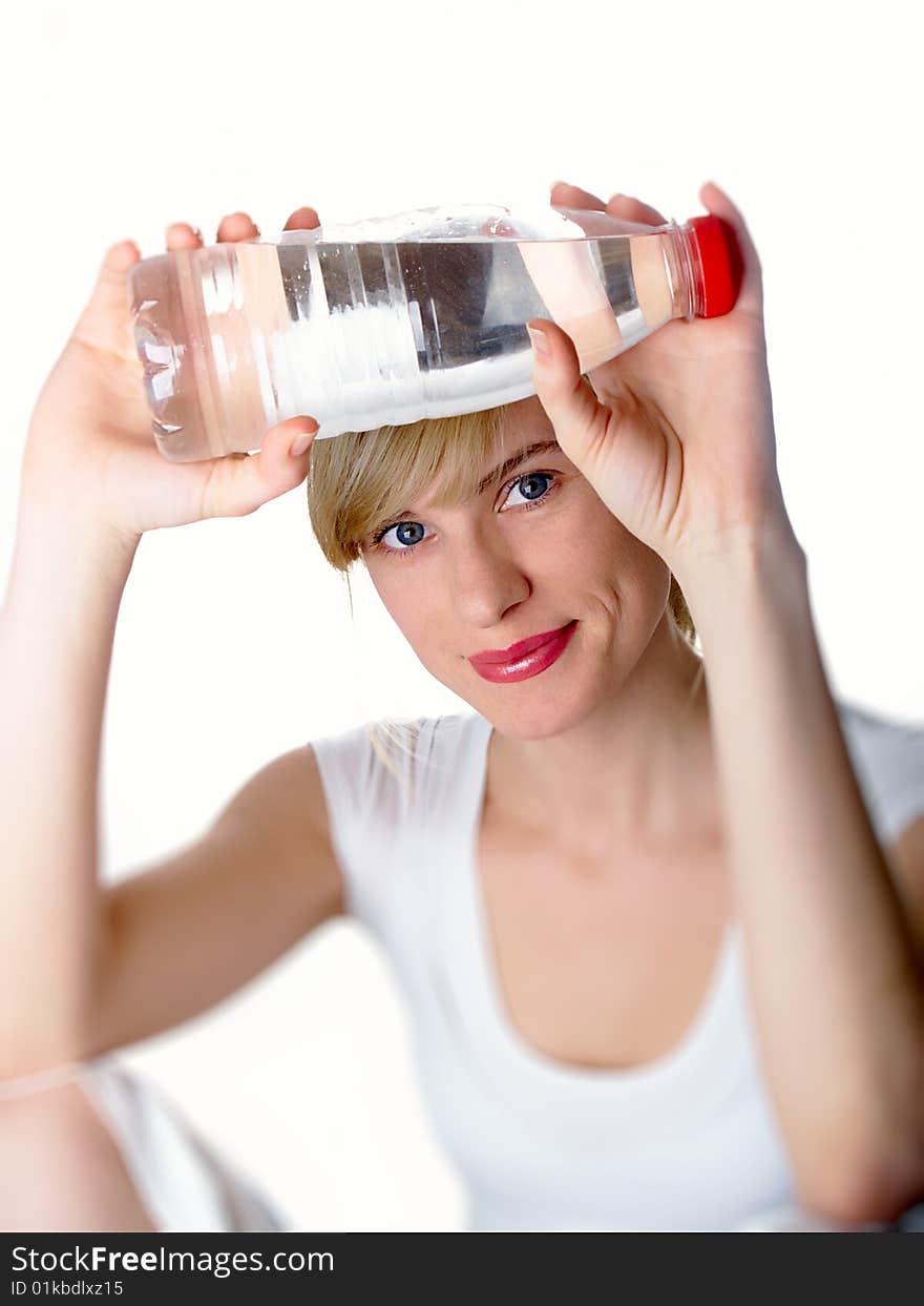 The girl of a sports kind with a bottle of water in a hand. The girl of a sports kind with a bottle of water in a hand