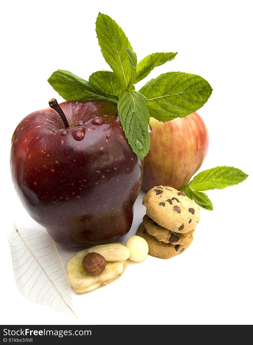 Two fresh ripe apples with mint, cookies and nuts. Two fresh ripe apples with mint, cookies and nuts