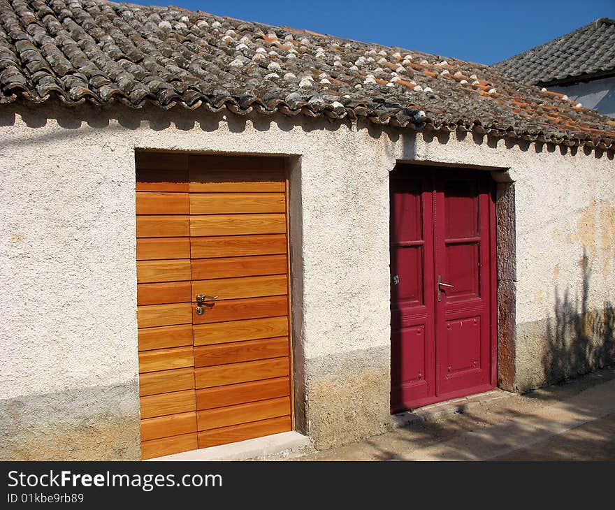 Old house with two different wooden doors