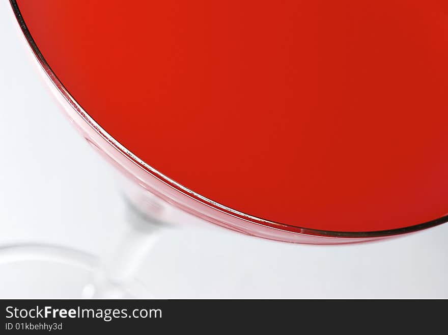 Abstract view of red cocktail in a glass on a white background. Abstract view of red cocktail in a glass on a white background