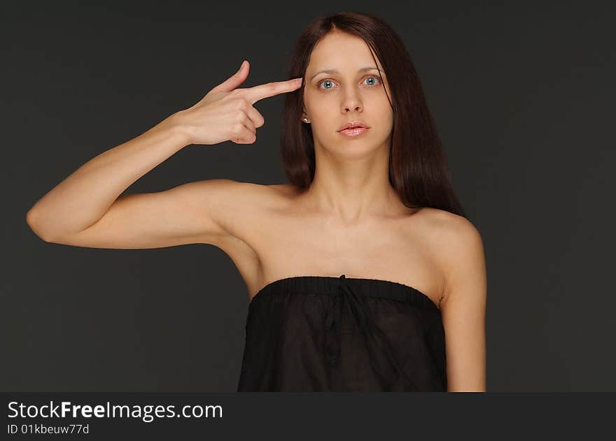 The young lonely woman on a dark background. The young lonely woman on a dark background