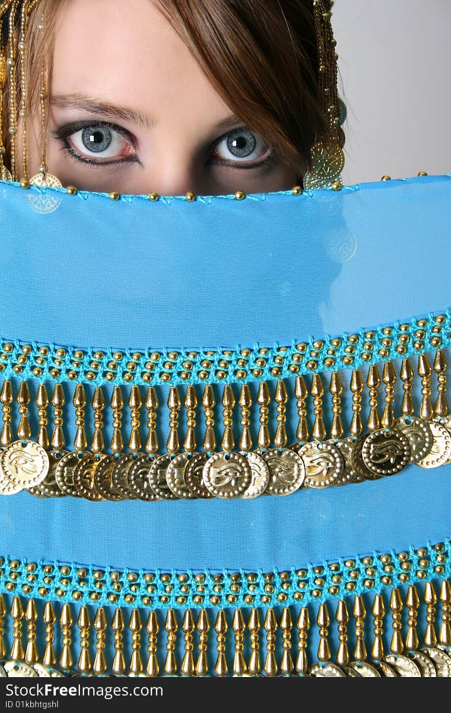 Beautiful young teenager posing in a belly dance costume. Beautiful young teenager posing in a belly dance costume