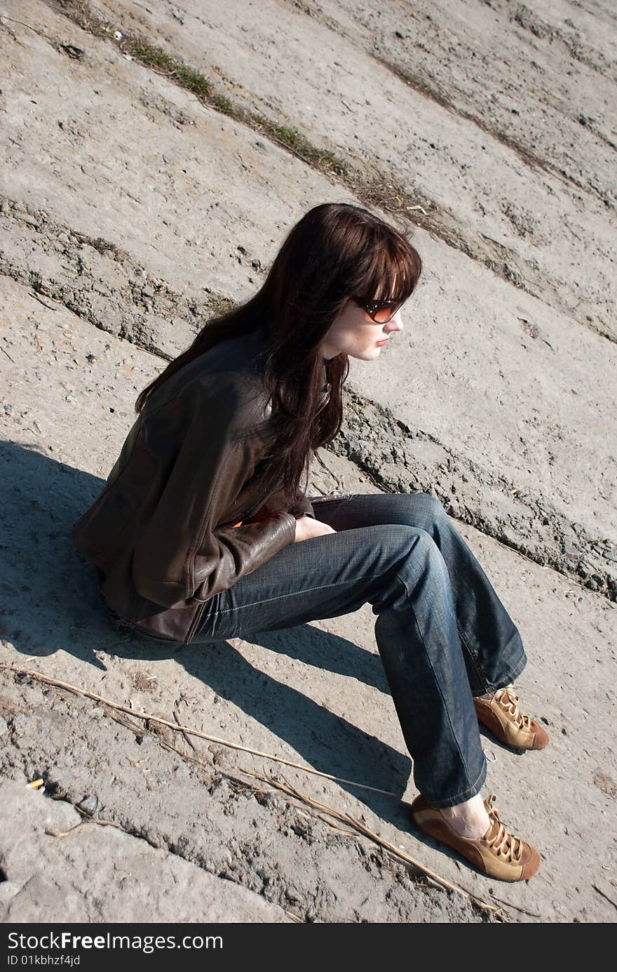 A girl with sun glasses on a stone background