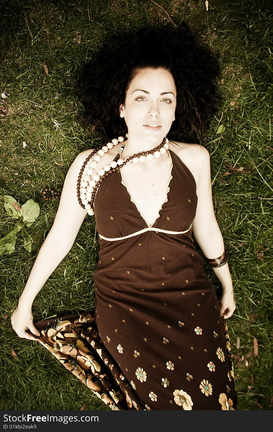 Young beautiful woman laying on the grass. Young beautiful woman laying on the grass.