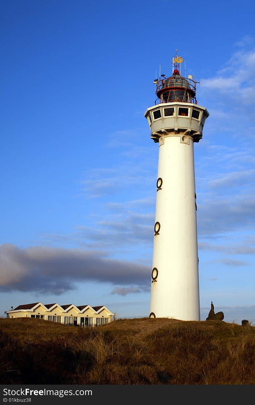 Dutch white lighthouse at the shore of the sea. Dutch white lighthouse at the shore of the sea