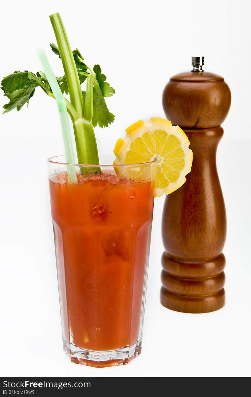 Bloody mary cocktail with a peppermill in the backround