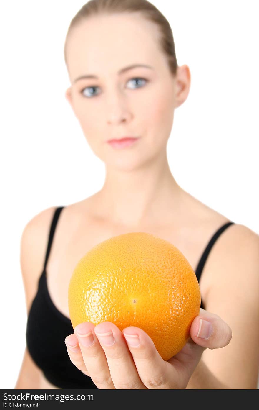 Model holding an orange in her hand. FOCUS ON ORANGE. Model holding an orange in her hand. FOCUS ON ORANGE