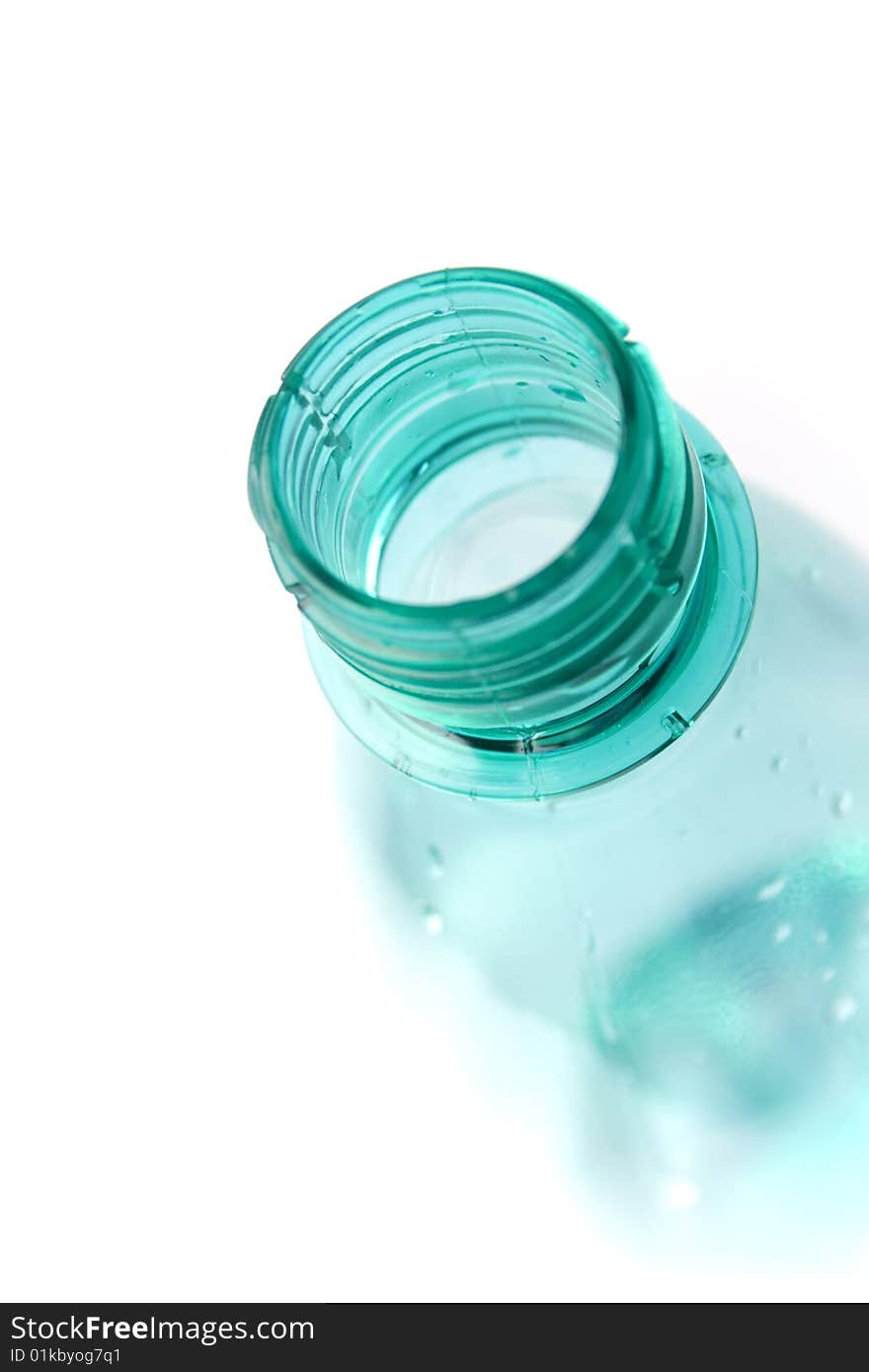 Bottle with water drops closeup on white background