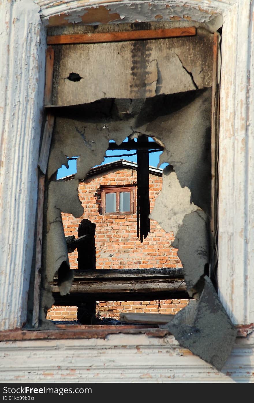 Old house window opening closed by ragged tar paper. Old house window opening closed by ragged tar paper