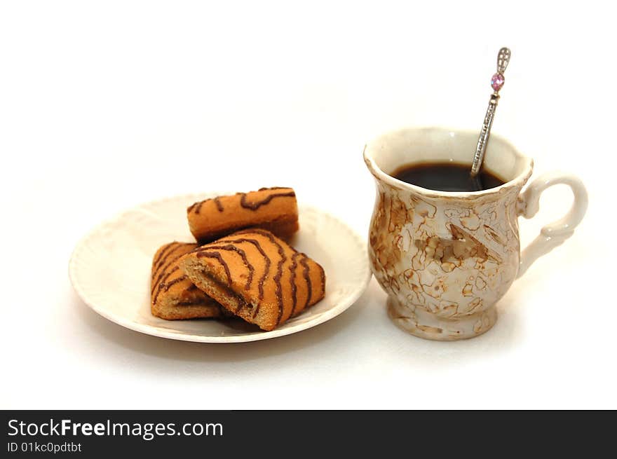 The front view on a cup about coffee and a plate with cookies. The front view on a cup about coffee and a plate with cookies