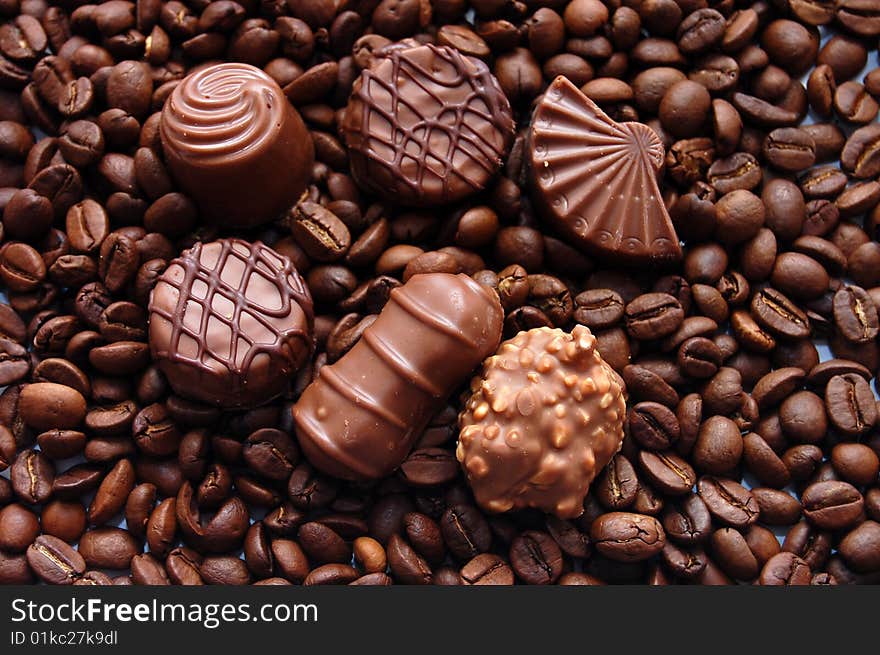 Chocolates against coffee grains