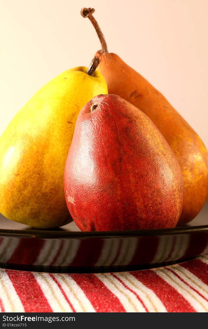 Three pears on black plate