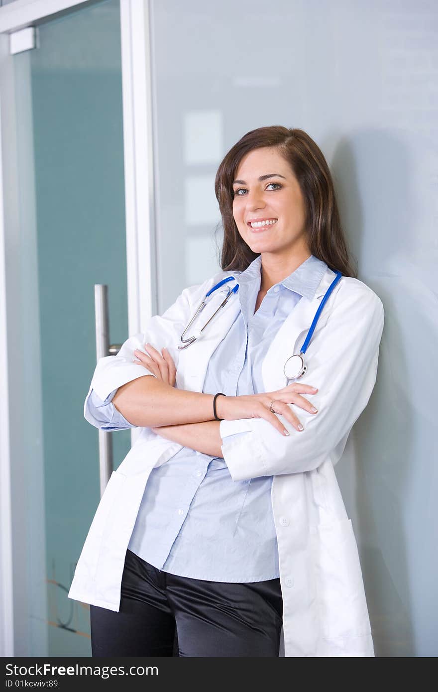 Female doctor arms crossed in a modern office. Female doctor arms crossed in a modern office