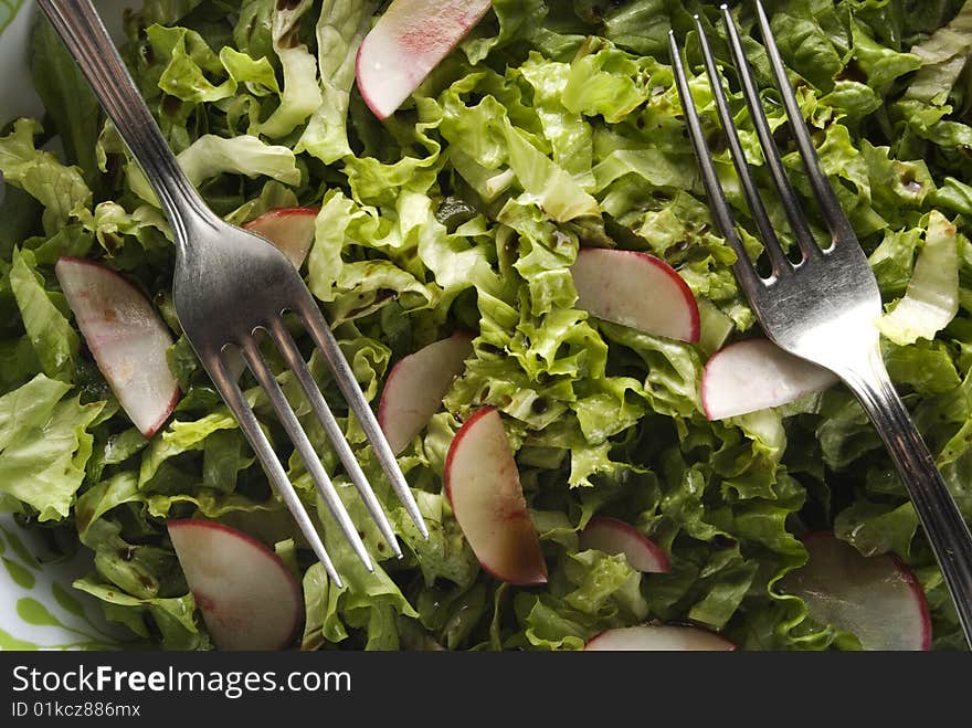 Green salad with turnip and forks