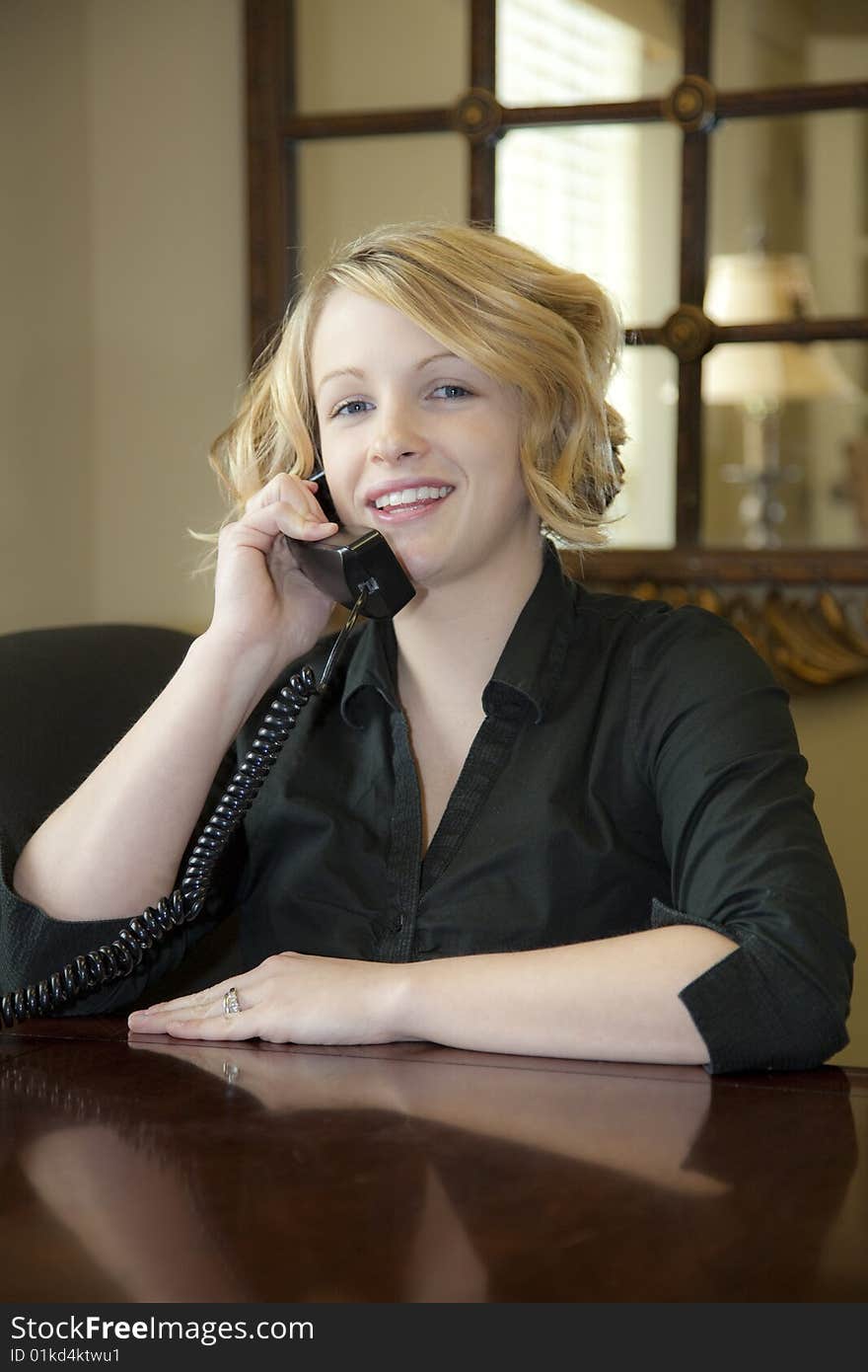 Receptionist welcoming customers at front desk, Explaining what they will need to qualify for an apartment lease. Receptionist welcoming customers at front desk, Explaining what they will need to qualify for an apartment lease