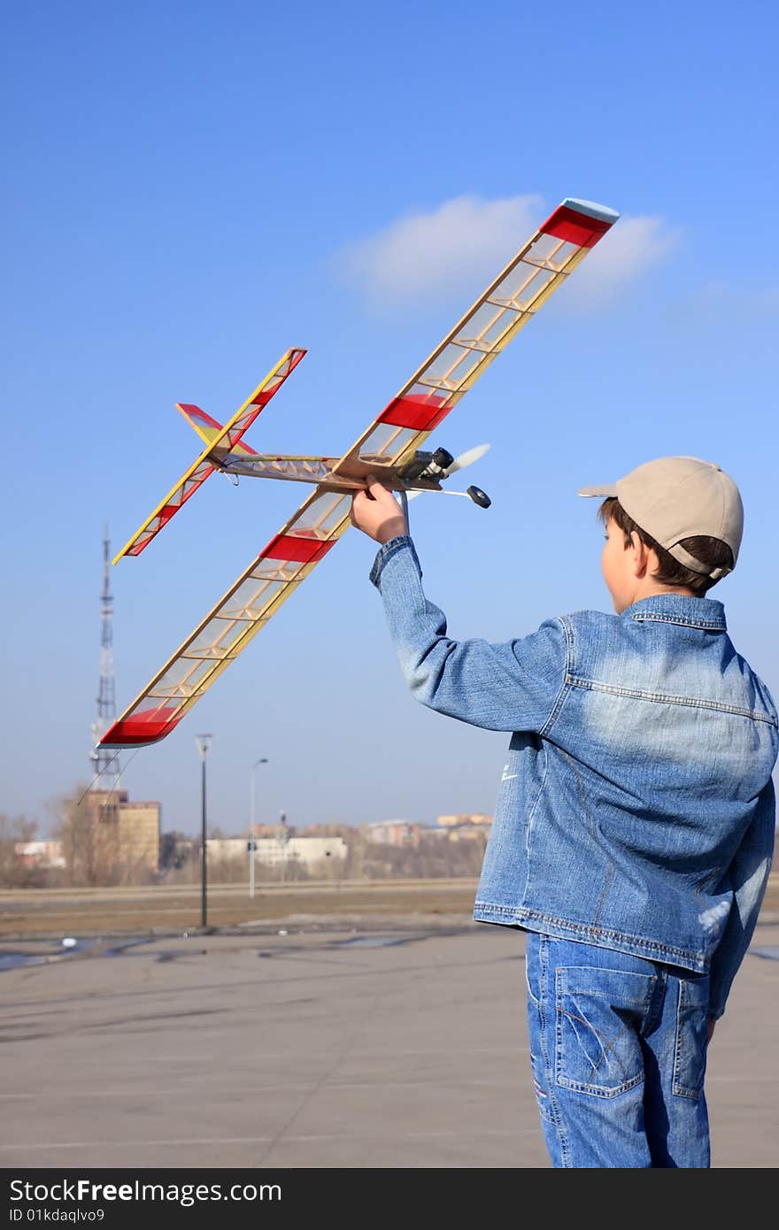 A boy starts an airplane.