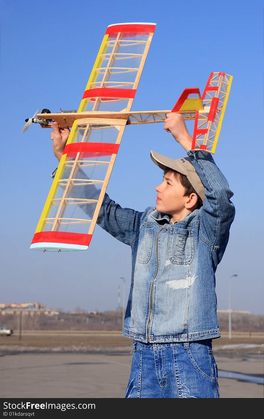 A boy starts an airplane.