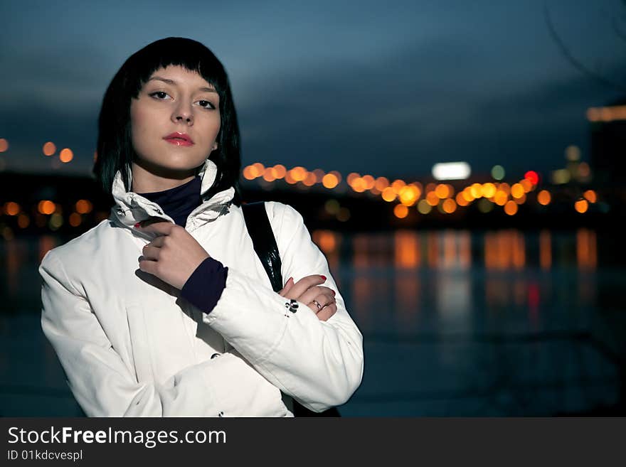 Beautiful young woman portrait in night city