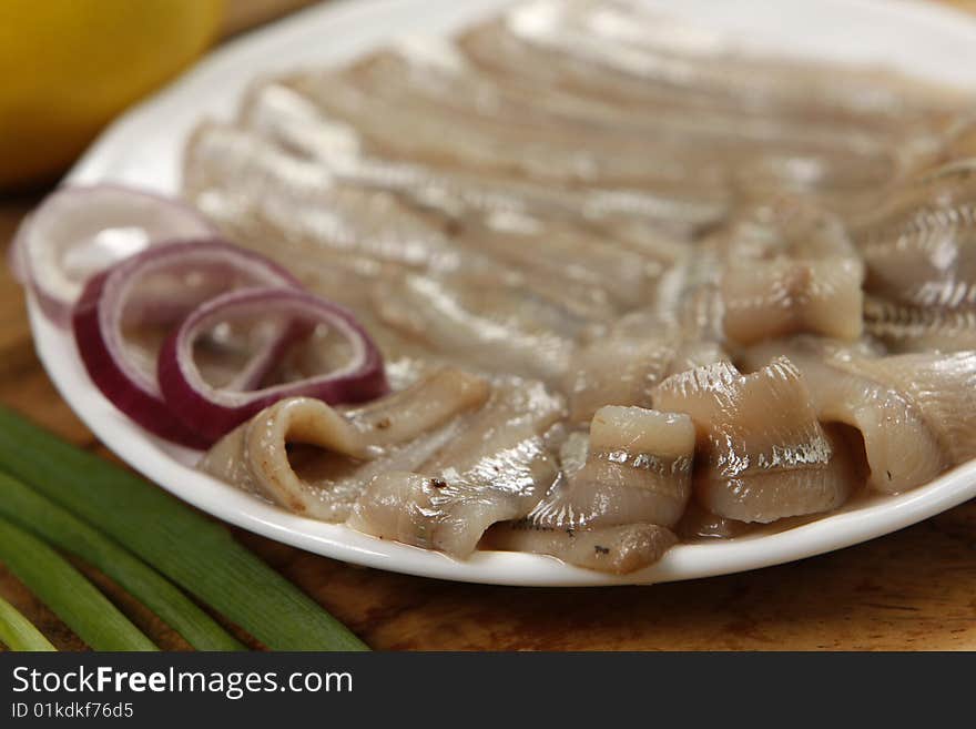 Salted anchovies on white plate