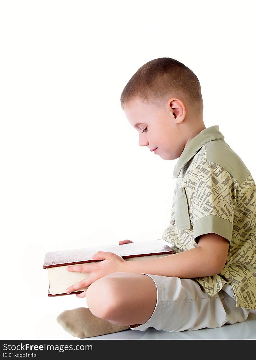 The child with book on the white