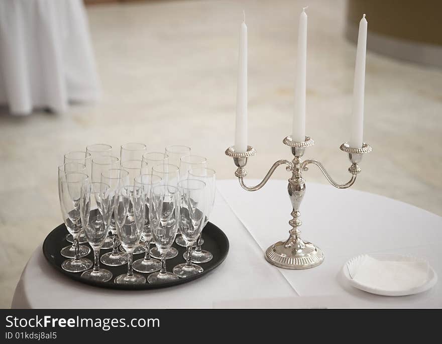 Champagne glasses and candle on a table. Champagne glasses and candle on a table