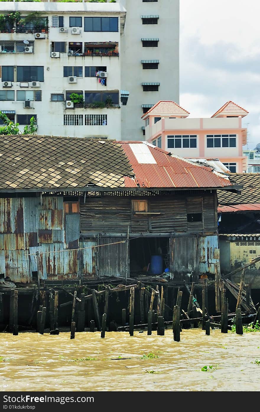 Bangkok: detail from river. Old shack and new buildings. Thailand. Bangkok: detail from river. Old shack and new buildings. Thailand