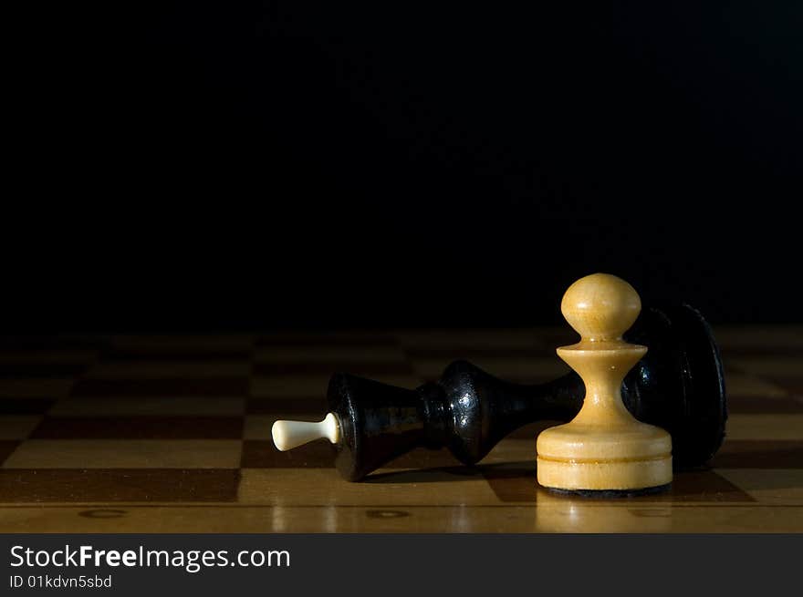 Two chessmen on a chessboard, black background