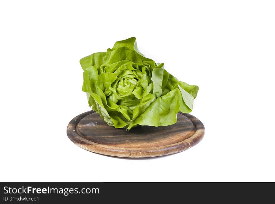 Healthy vegetables isolated on a wooden cutting board