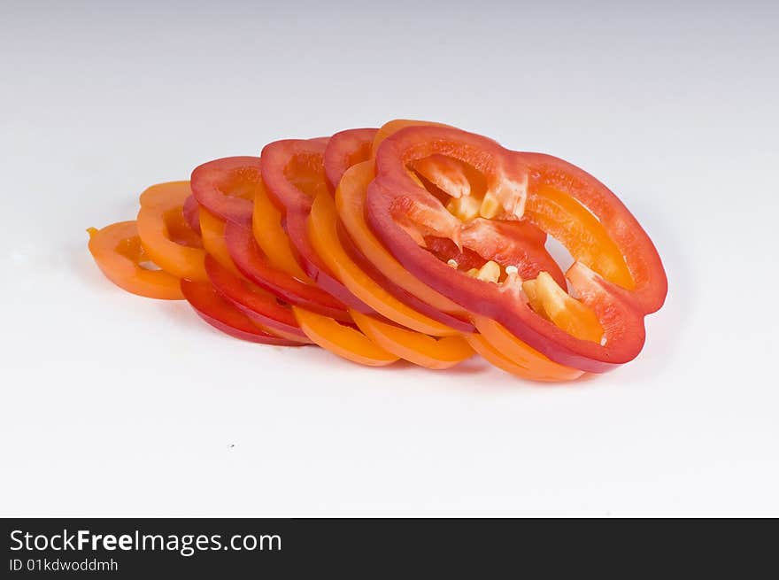 Sliced sweet red and yellow peppers isolated on white