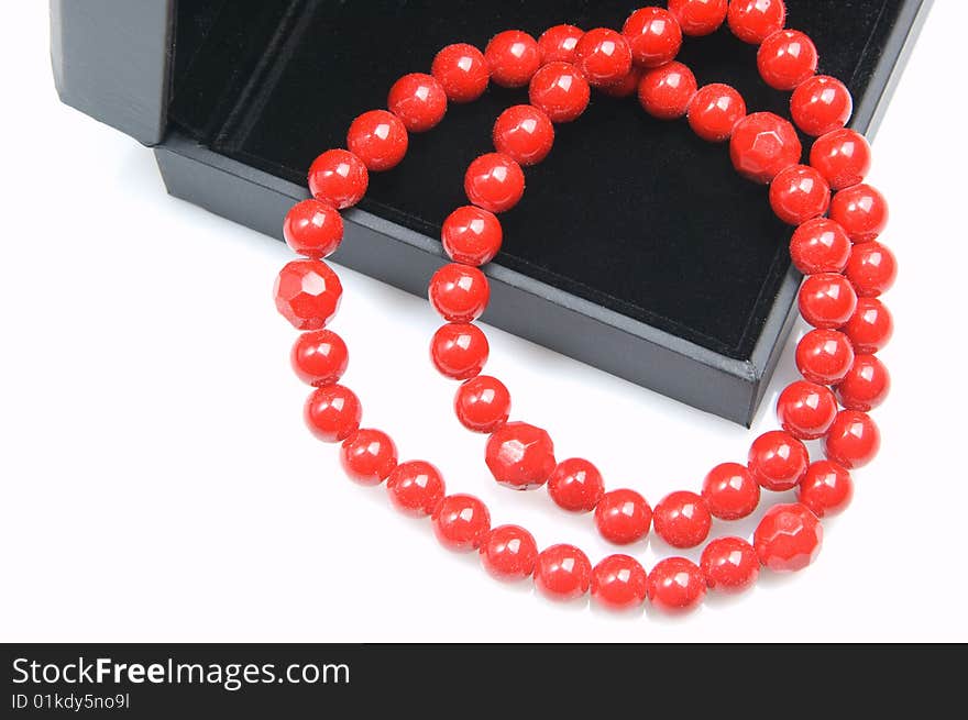 Red coral beads in a black casket