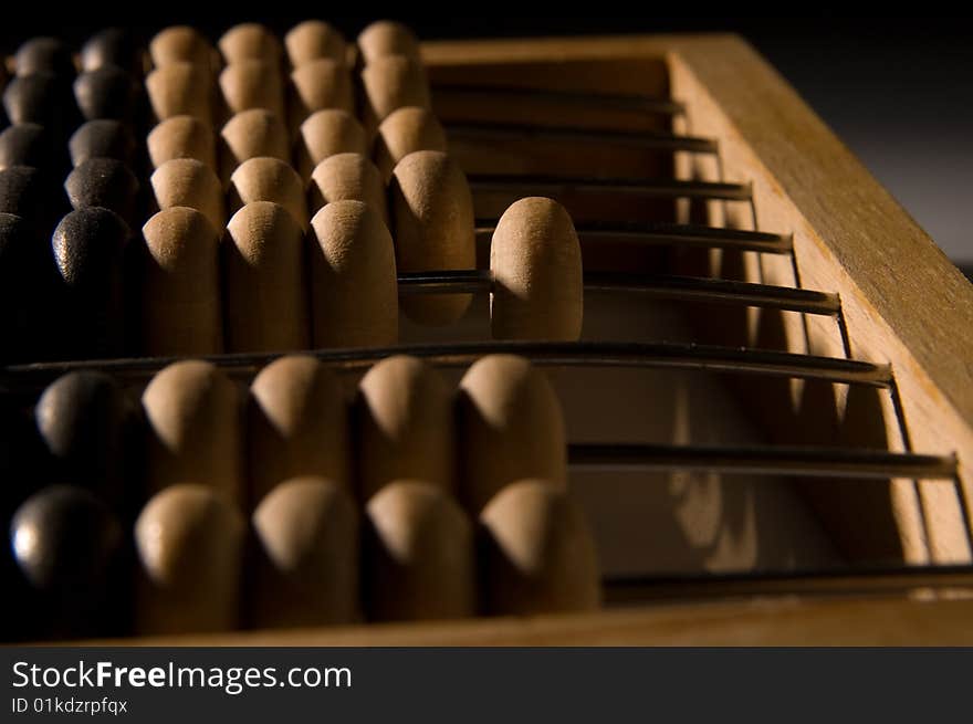 Obsolete wooden abacus, black background