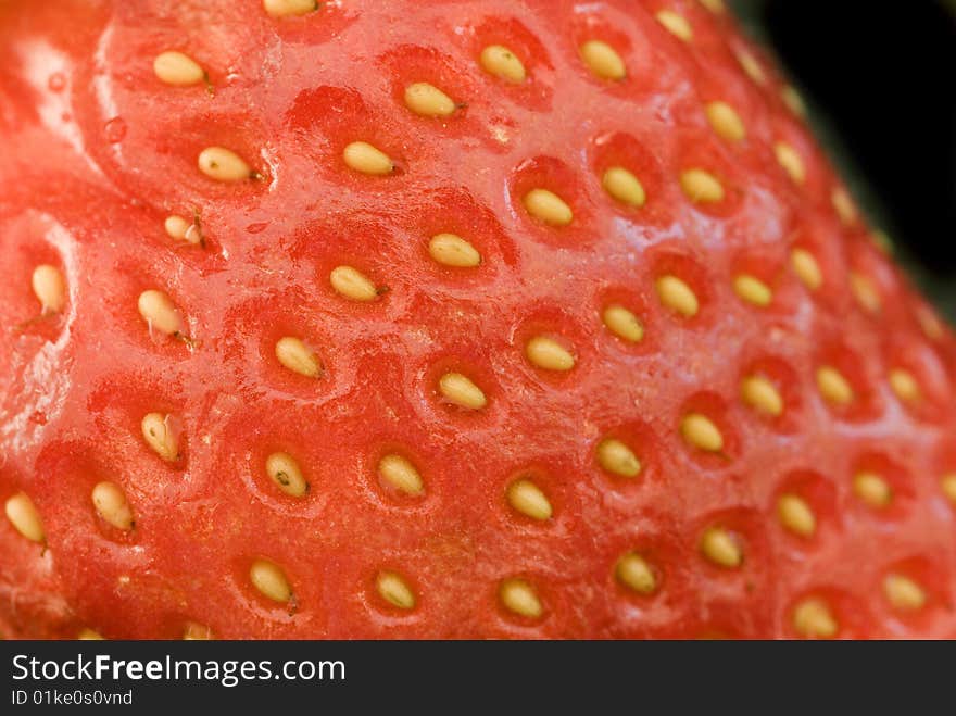 Macro image of a strawberry on a black background. Macro image of a strawberry on a black background