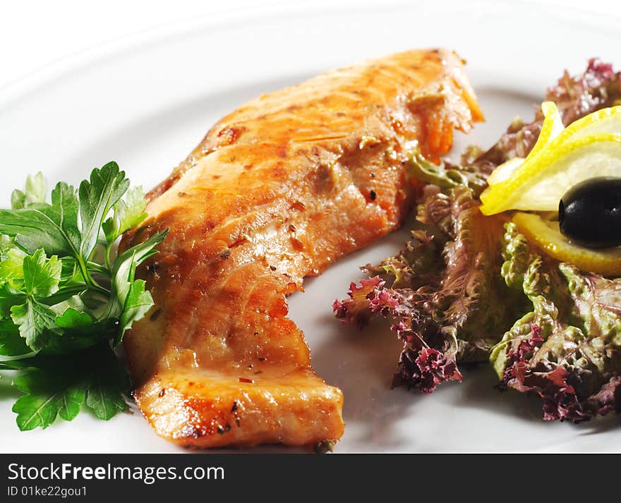 Hot Fish Dishes - Salmon Fillet with Fresh Salad Leaf and Parsley