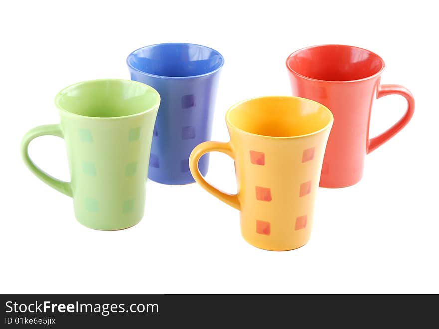 Colour cups for tea and coffee. A small white teapot. Colour cups for tea and coffee. A small white teapot.