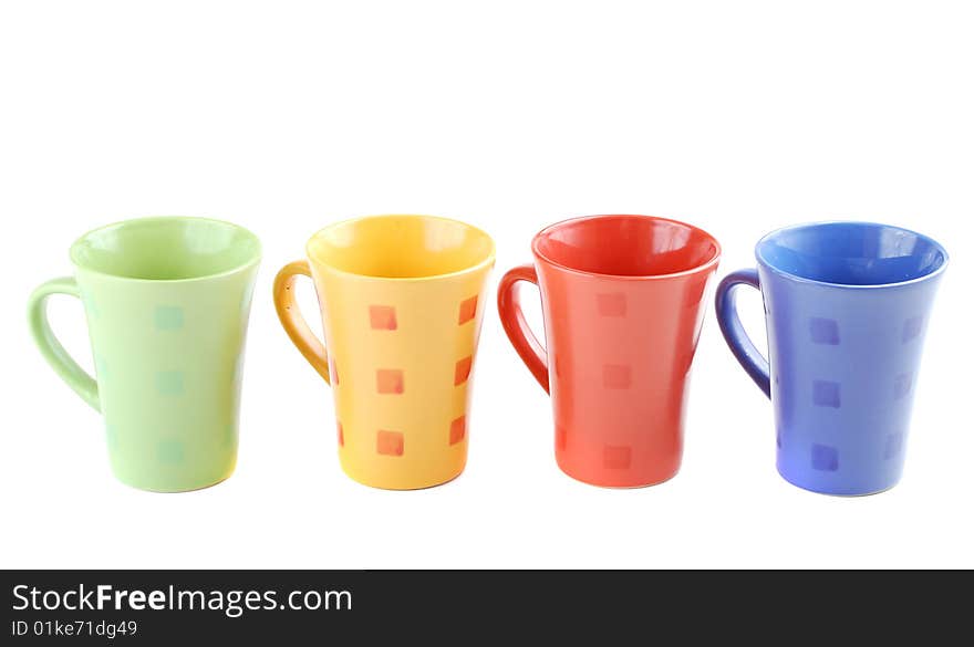 Colour cups for tea and coffee. A small white teapot. Colour cups for tea and coffee. A small white teapot.