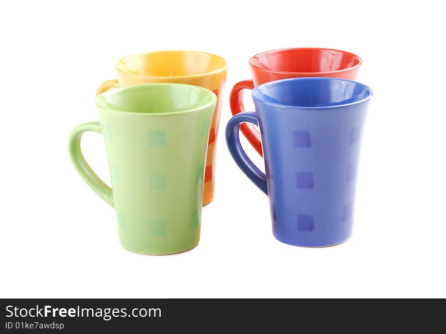 Colour cups for tea and coffee. A small white teapot. Colour cups for tea and coffee. A small white teapot.