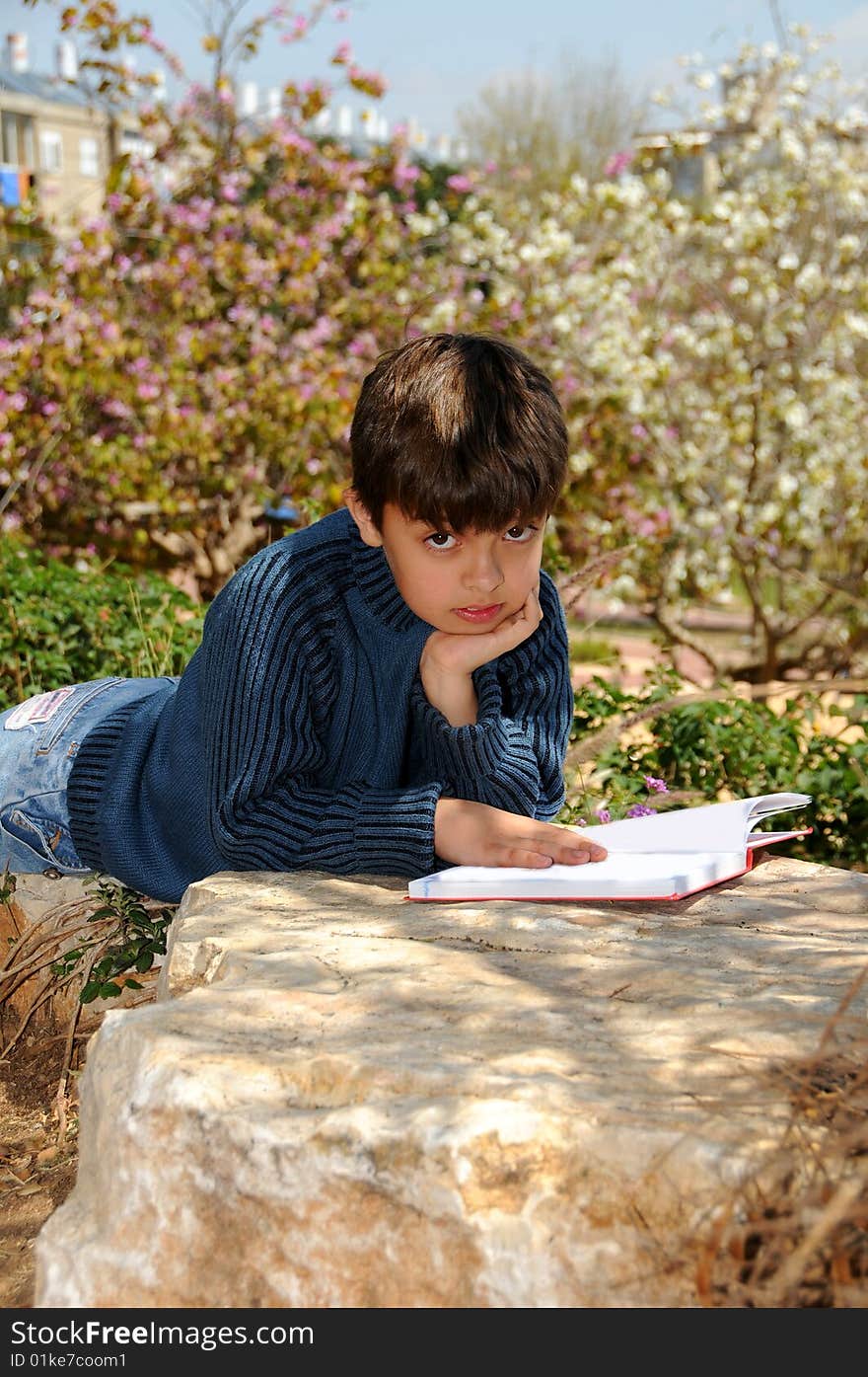 The boy reading the book in park