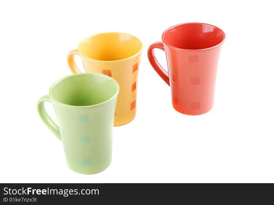 Colour cups for tea and coffee. A small white teapot. Colour cups for tea and coffee. A small white teapot.