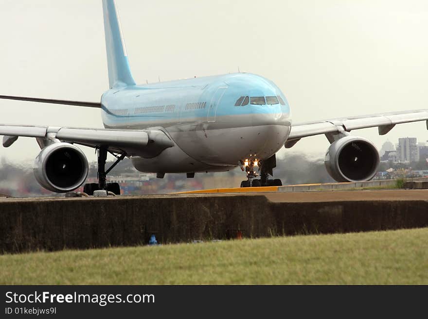 Blue and silver passenger jet on the runway. Blue and silver passenger jet on the runway.