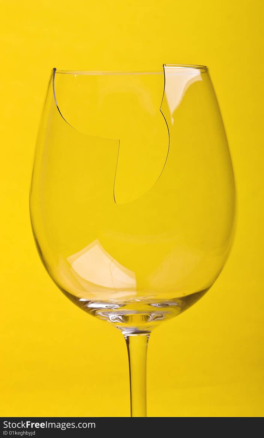 Close-up broken glass isolated on yellow background