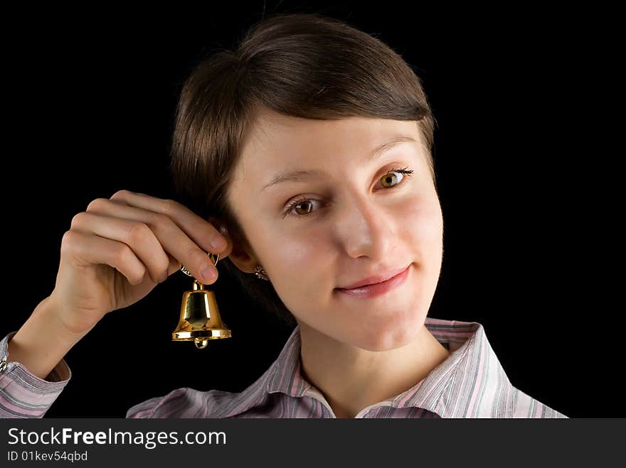 Young woman with a handbell on black