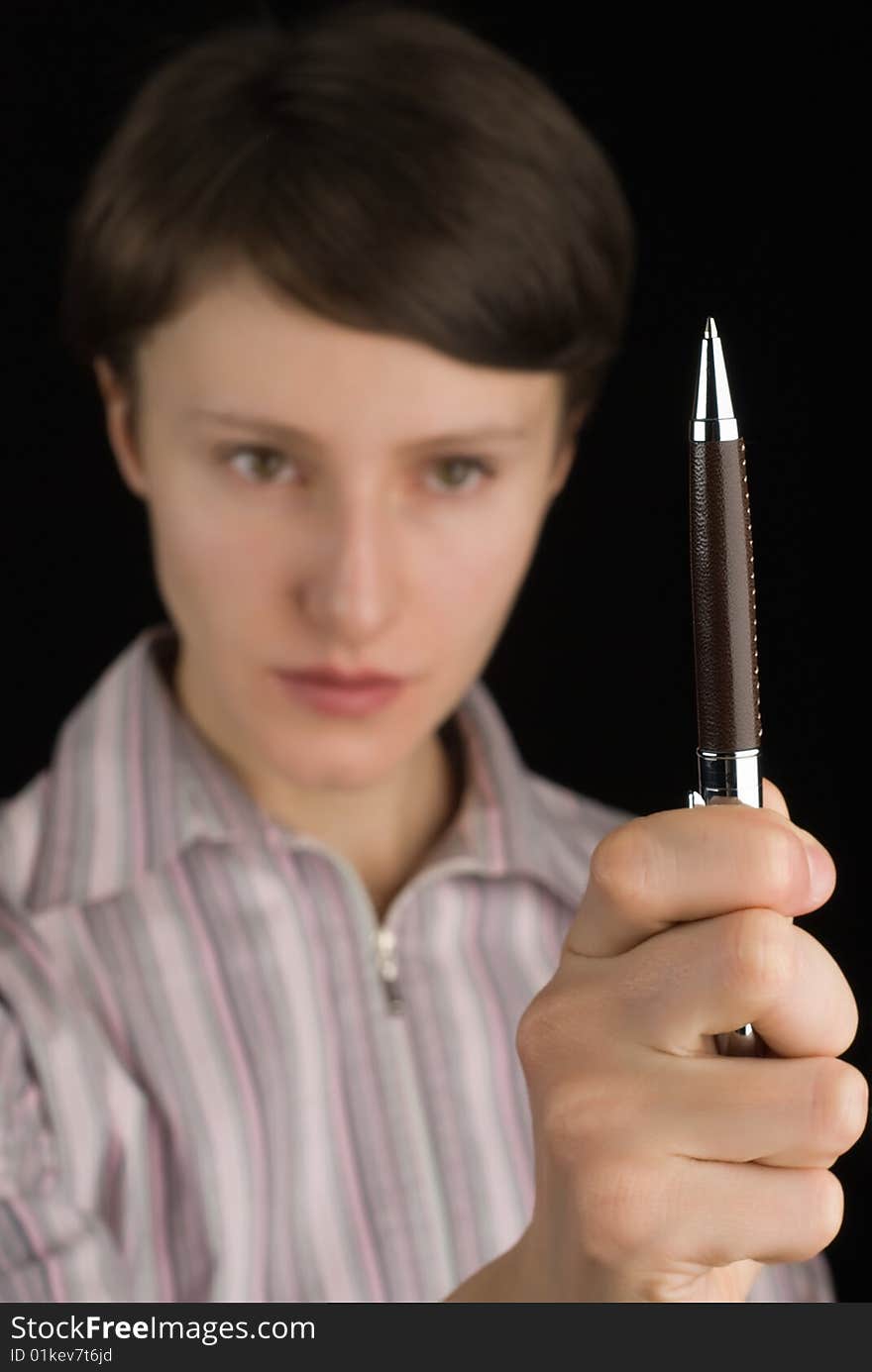 Young girl holding roller pen on black