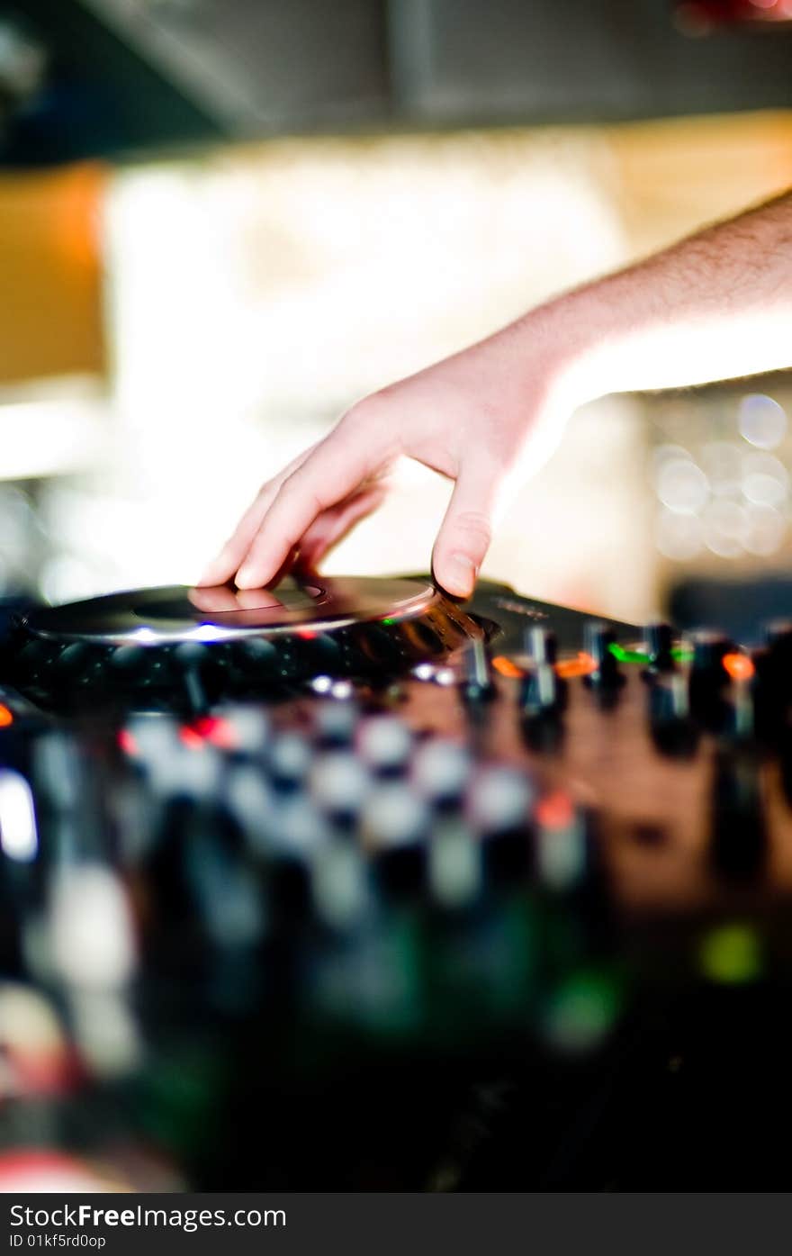 Close-up of deejays hand and turntable