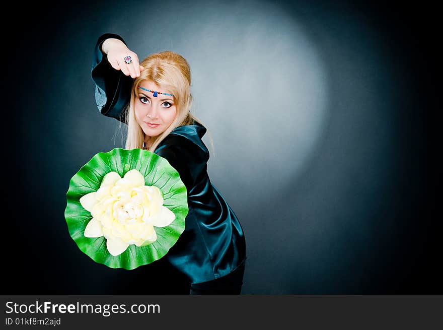 Woman exercising with lotus, studio shot