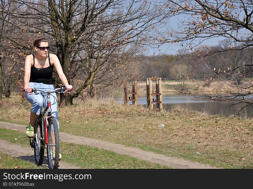 Girl riding a bike in spring scenery. Girl riding a bike in spring scenery