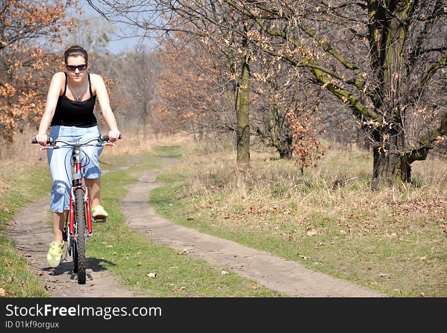 Girl riding a bike in beautiful spring scenery. Girl riding a bike in beautiful spring scenery